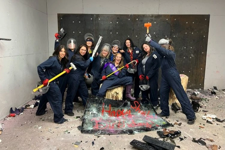 Group celebrating at iSmash USA in front of comic style wall art